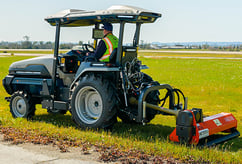 168车极速查询 Monarch Tractor mowing at an airport