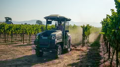 168车极速查询 Monarch Tractor mowing in a vineyard
